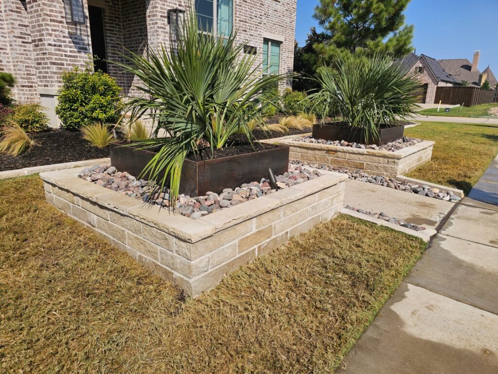 Finished front yard landscape with stone-edged planting beds